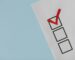 A simple white paper checklist with one red checkmark, ideal for concepts like completion or approval.